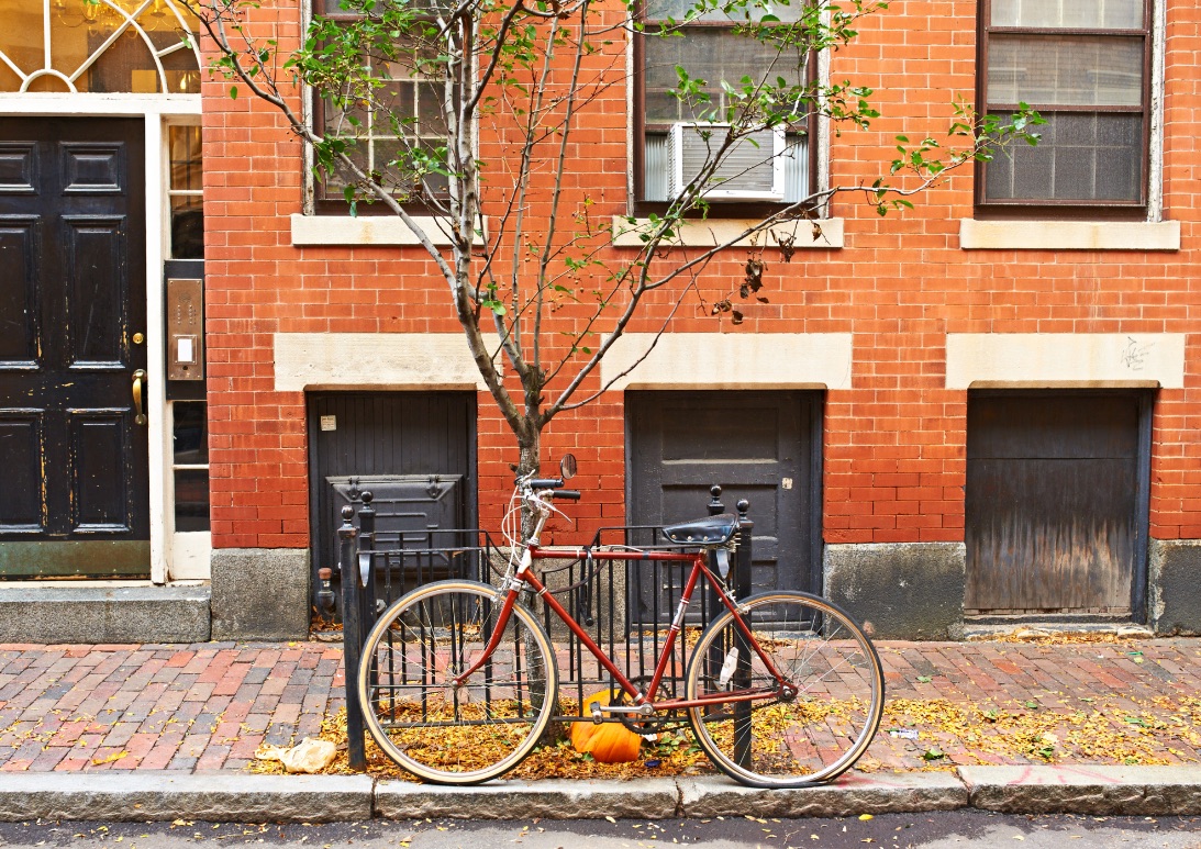 red bike in front of brownstone home in Boston