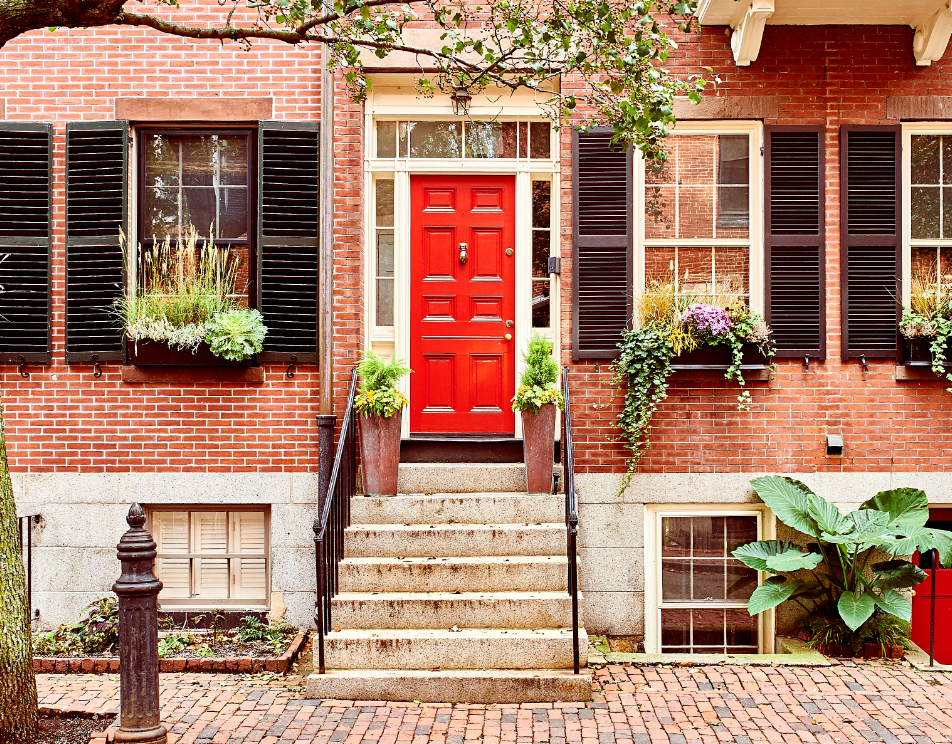 brownstone home in Boston with red front door  